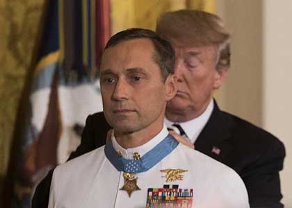 WASHINGTON (May 24, 2018) President Donald J. Trump presents the Medal of Honor to retired Master Chief Special Warfare Operator (SEAL) Britt Slabinski during a ceremony at the White House in Washington, D.C. Slabinski received the Medal of Honor for his actions during Operation Anaconda in Afghanistan in March 2002. (U.S. Navy photo by MC1 Raymond D. Diaz III.