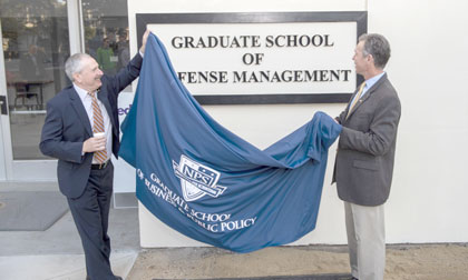 Dr. Steven Lerman, NPS Provost and Academic Dean, left, and Dr. Keith Snider, Dean of the Graduate School of Defense Management, unveil new signage for Ingersoll Hall during a brief ceremony marking the newly-renamed Graduate School of Defense Management, Oct. 1.
