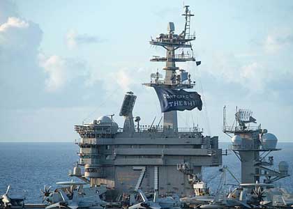 PHILIPPINE SEA (June 3, 2020) The aircraft carrier USS Theodore Roosevelt (CVN 71) flies a replica of Capt. Oliver Hazard Perry's "Don't Give Up the Ship" flag, June 3, 2020. Following an extended visit to Guam in the midst of the COVID-19 global pandemic, Theodore Roosevelt completed carrier qualifications June 2 and is in Guam for resupply during a deployment to the Indo-Pacific. U.S. Navy photo by Naval Air Crewman (Helicopter) 1st Class Will Bennett.