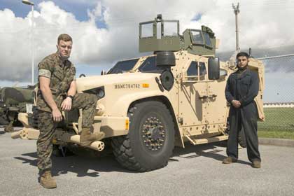 OKINAWA, JAPAN — (left to right) U.S. Marine Lance Cpl. Evan M. Simonds, a motor transport operator with Truck Co., Headquarters Bn., 3rd Marine Division, and Lance Cpl. Eduardo Tenaperez, motor transport mechanic, stand with the Joint Light Tactical Vehicle (JLTV) here, Sep. 18. The vehicle is one of two models currently being fielded and maintained with the unit. Eventually, the JLTV will replace the Humvee and revolutionize the mobility and reliability of motor transportation throughout the Marine Corps. U.S. Marine Corps photo by Gunnery Sgt. Jacob H. Harrer.