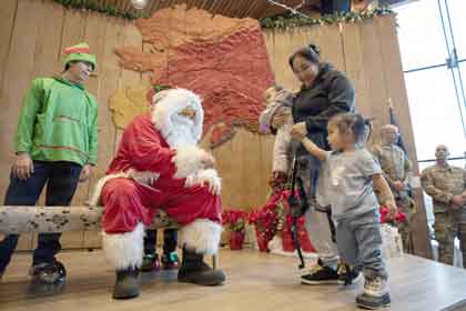 OPERATION SANTA CLAUS: Members of the Alaska National Guard and the Department of Homeland Security, along with volunteers from the Salvation Army and the Alaska National Guard Child and Youth Program, host families from Kipnuk and Kwigillingok during Operation Santa Claus at the Alaska Native Heritage Center in Anchorage, Alaska, Dec. 14, 2025. Operation Santat Claus provides gifts, toys, backpacks and books to children in remote Alaskan communities. This year's event supported families who were dispalced followint typhoon Halong. U.S. Army photo by Alejandro Pena.